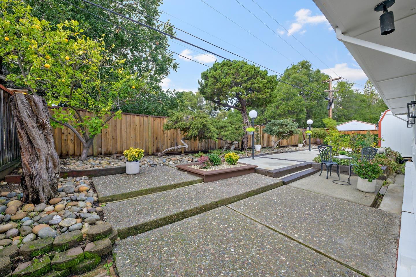 10275 Farallone Drive Cupertino, CA 95014 - Photo 16 of 17 a view of a backyard with plants and a garden