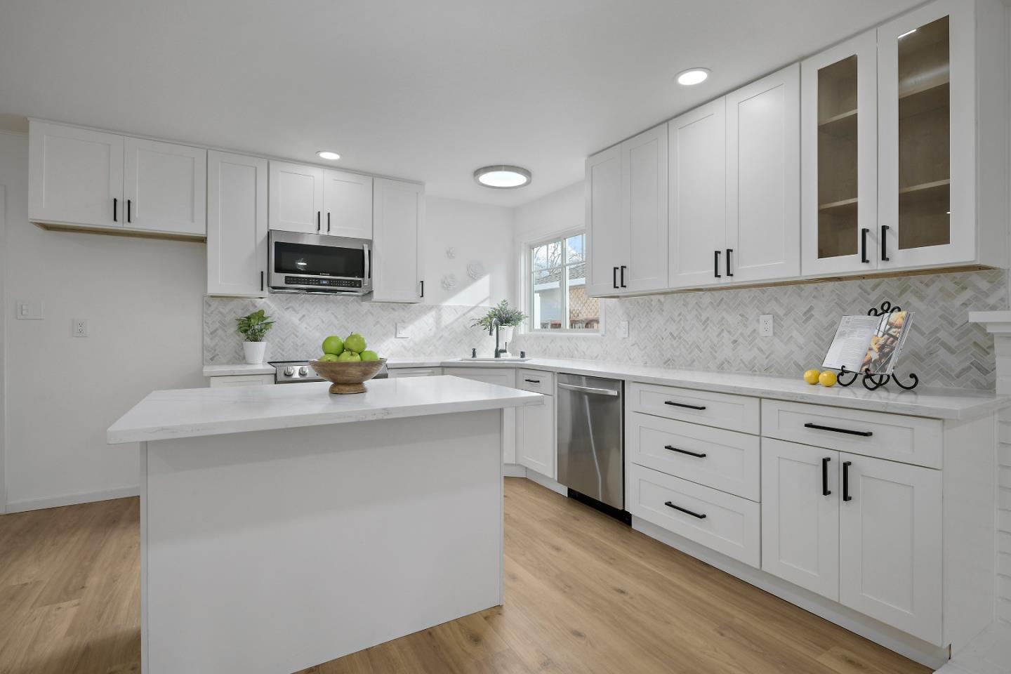 10275 Farallone Drive Cupertino, CA 95014 - Photo 8 of 17 a kitchen with stainless steel appliances kitchen island granite countertop a sink a stove and cabinets