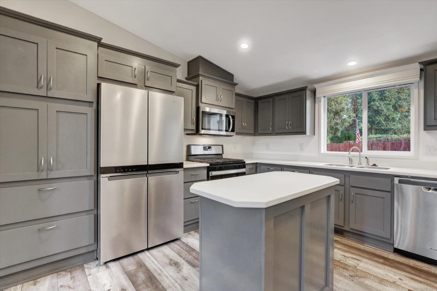 11195 Alpine Lane Grass Valley, CA 95945 - Photo 16 of 71 a kitchen with appliances a sink and a refrigerator