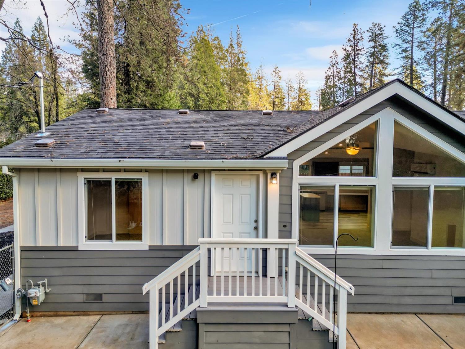 11195 Alpine Lane Grass Valley, CA 95945 - Photo 43 of 71 a view of a house with a large window and wooden fence