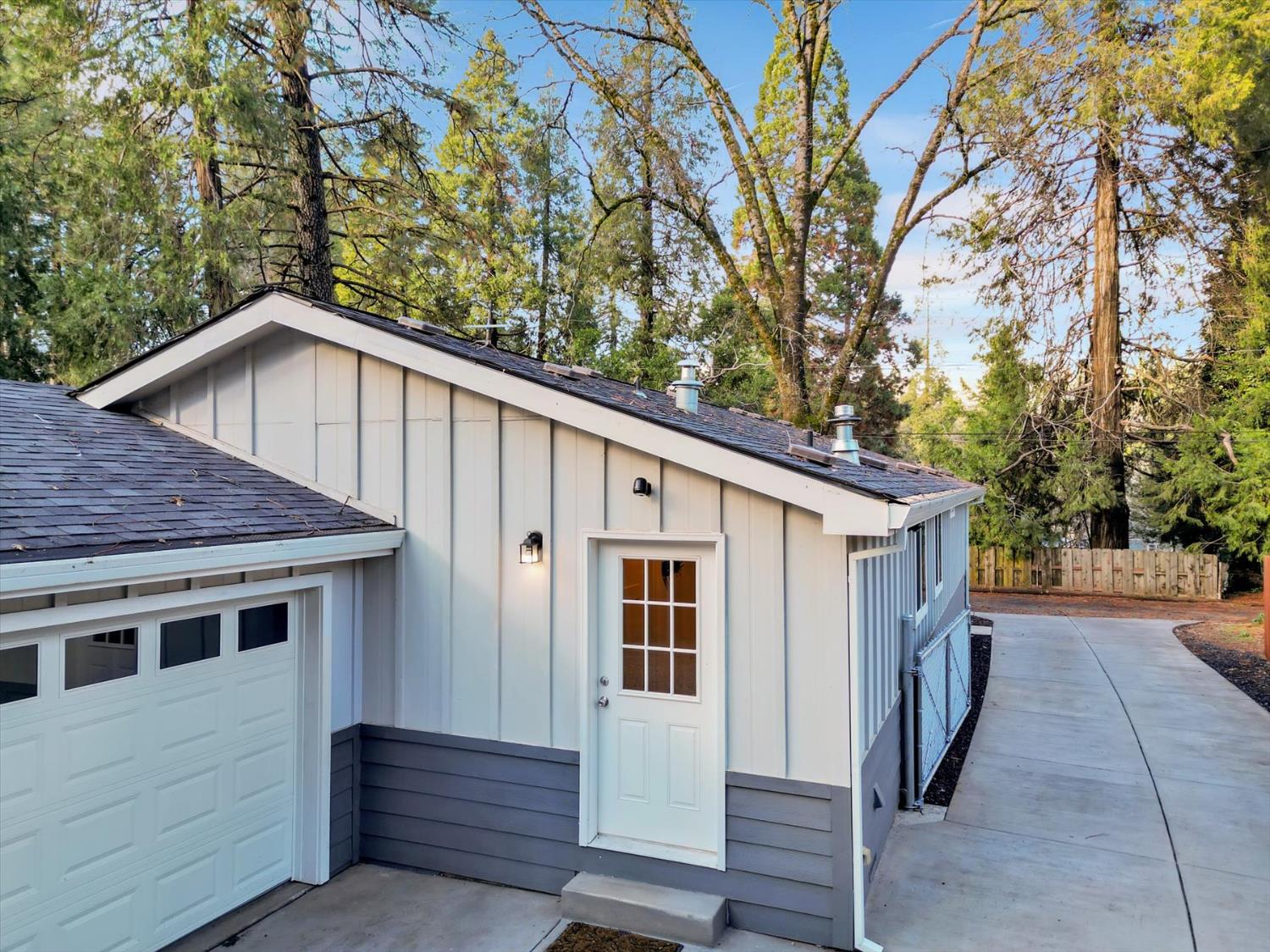11195 Alpine Lane Grass Valley, CA 95945 - Photo 48 of 71 a white house with a large tree and wooden fence