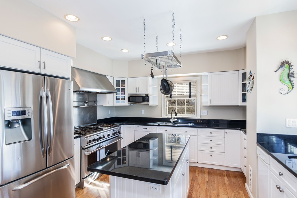 a kitchen with granite countertop a sink stainless steel appliances and counter space