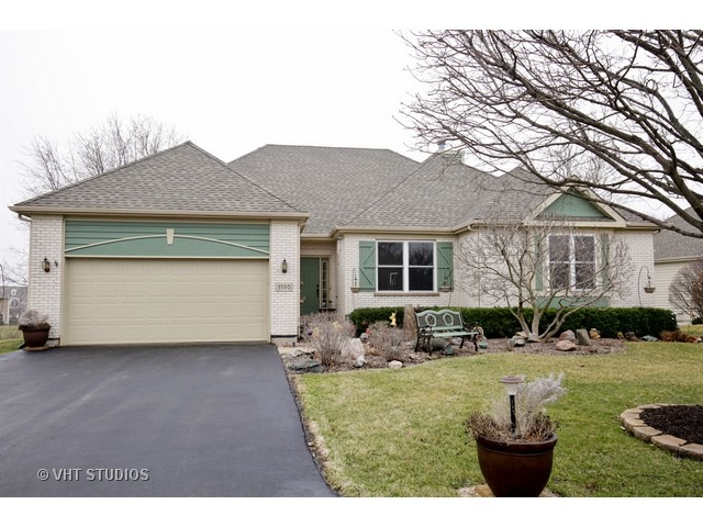 1150 Ridgewood Circle Lake In The Hills, IL 60156 - Photo 1 of 20 a front view of a house with a yard and garage