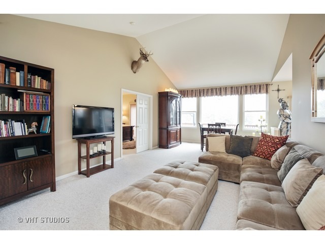 1150 Ridgewood Circle Lake In The Hills, IL 60156 - Photo 2 of 20 a living room with furniture and a flat screen tv