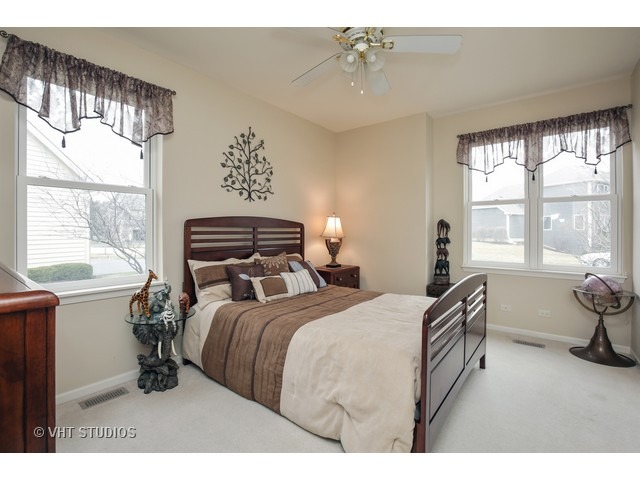 1150 Ridgewood Circle Lake In The Hills, IL 60156 - Photo 15 of 20 a bedroom with a bed and a large window