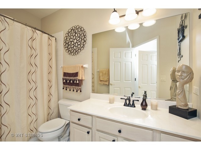 1150 Ridgewood Circle Lake In The Hills, IL 60156 - Photo 17 of 20 a bathroom with a sink a toilet and a mirror