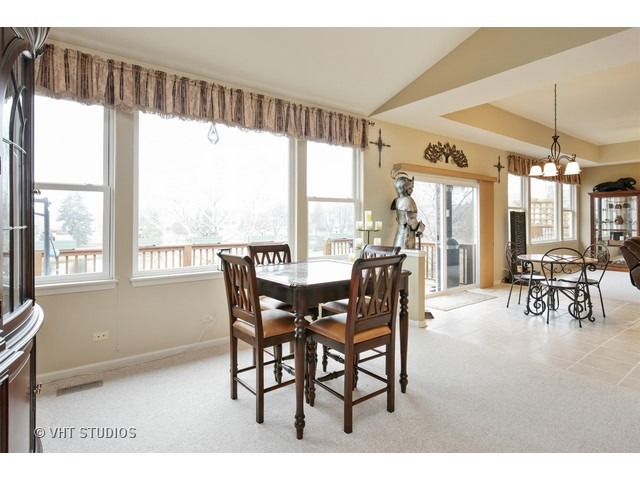 1150 Ridgewood Circle Lake In The Hills, IL 60156 - Photo 5 of 20 a dining room with furniture water view and a floor to ceiling window