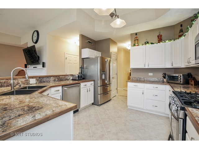 1150 Ridgewood Circle Lake In The Hills, IL 60156 - Photo 6 of 20 a kitchen with a sink stove and refrigerator