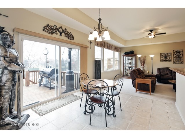 1150 Ridgewood Circle Lake In The Hills, IL 60156 - Photo 7 of 20 a view of a dining room with furniture wooden floor and a chandelier