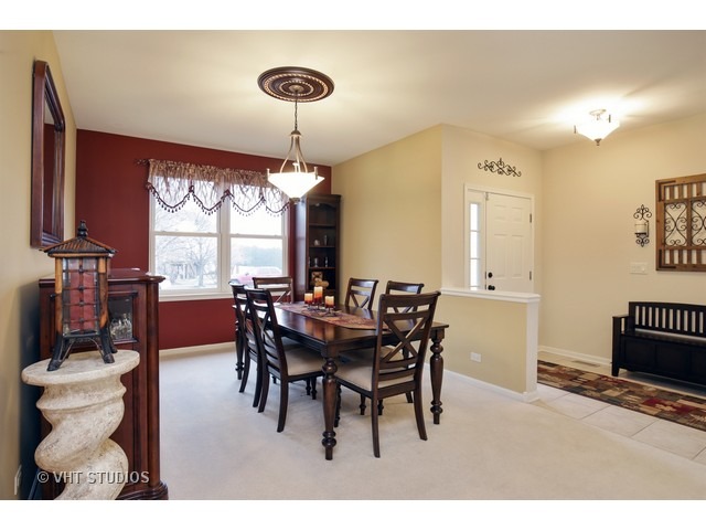 1150 Ridgewood Circle Lake In The Hills, IL 60156 - Photo 8 of 20 a view of a dining room with furniture and window