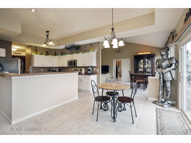 1150 Ridgewood Circle Lake In The Hills, IL 60156 - Photo 9 of 20 a view of a dining room with furniture and chandelier