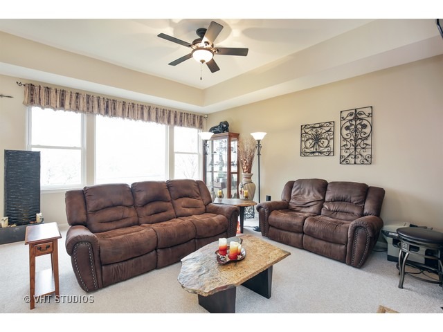 1150 Ridgewood Circle Lake In The Hills, IL 60156 - Photo 10 of 20 a living room with furniture ceiling fan and a window