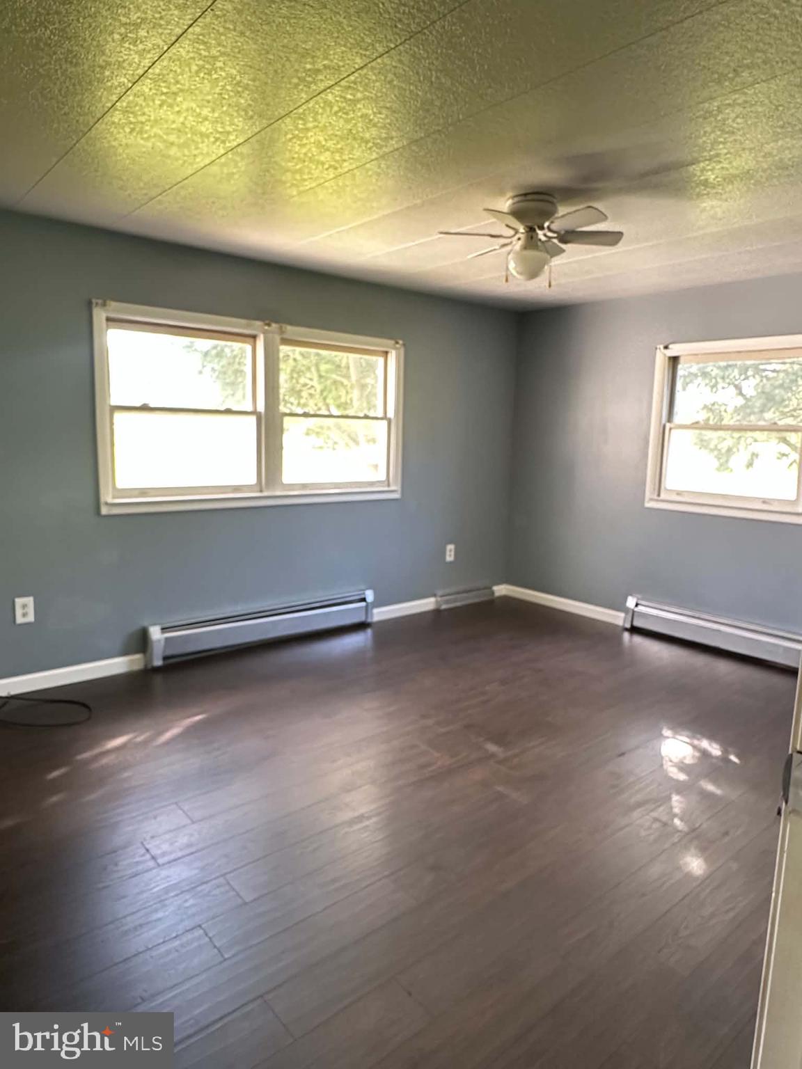 805 Baltimore Road Shippensburg, PA 17257 - Photo 11 of 23 an empty room with wooden floor and windows
