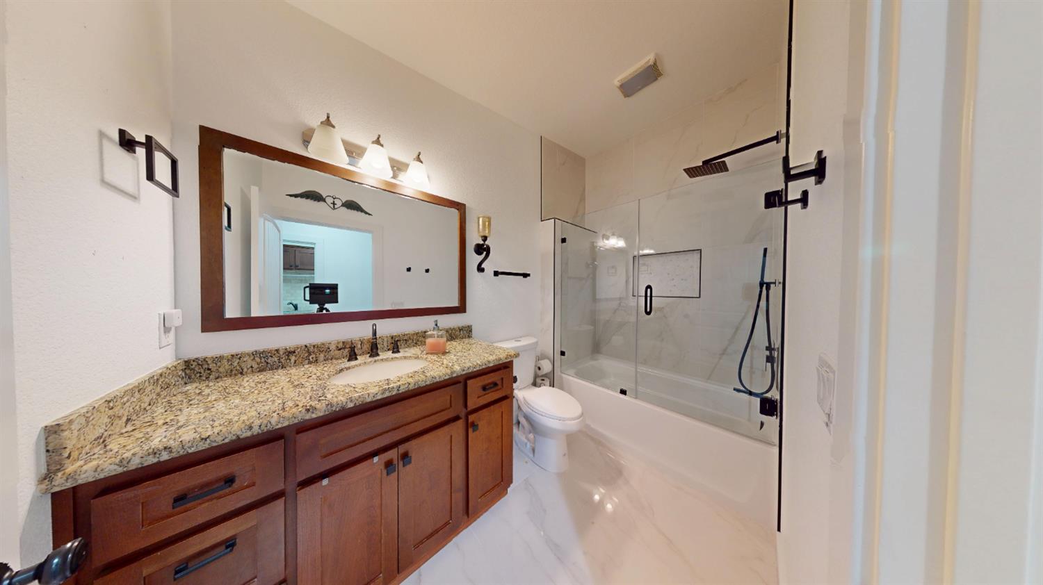 4460 South Carpenter Road Modesto, CA 95358 - Photo 15 of 40 a bathroom with a granite countertop double vanity sink mirror and shower