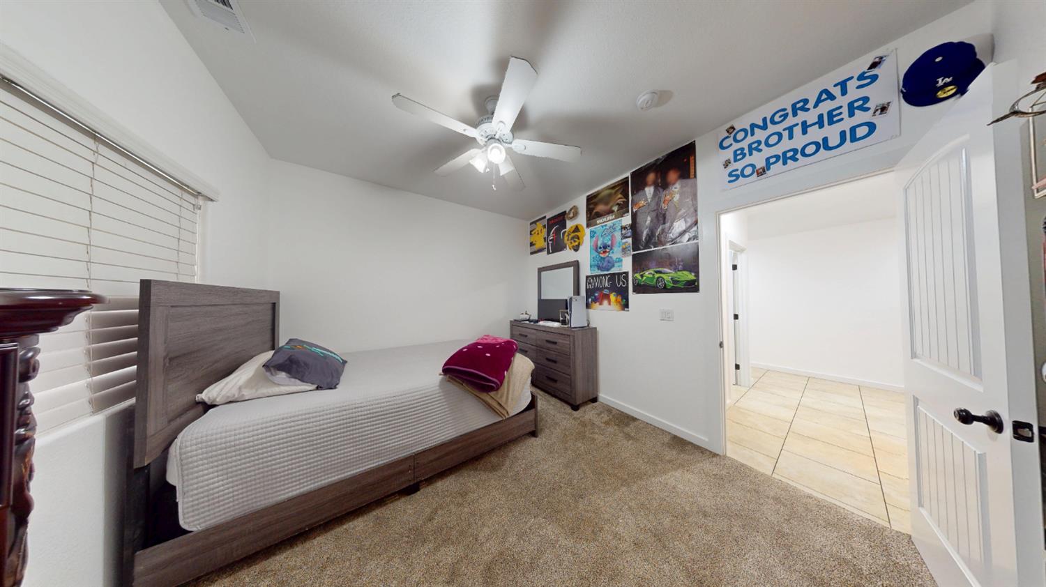 4460 South Carpenter Road Modesto, CA 95358 - Photo 16 of 40 a bedroom with furniture and a chandelier