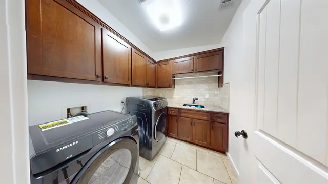 a kitchen with a sink cabinets and appliances