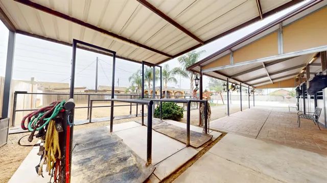 a roof deck with table and chairs under an umbrella