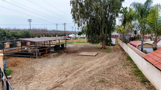 a view of a swimming pool with a patio and a backyard