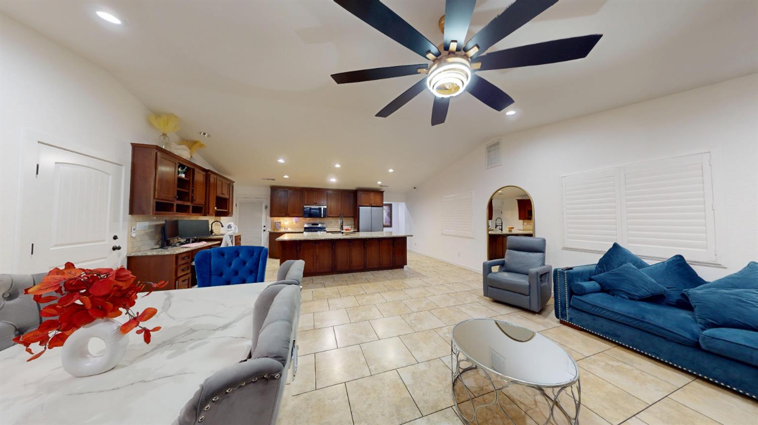 4460 South Carpenter Road Modesto, CA 95358 - Photo 10 of 40 a living room with furniture kitchen view and a flat screen tv