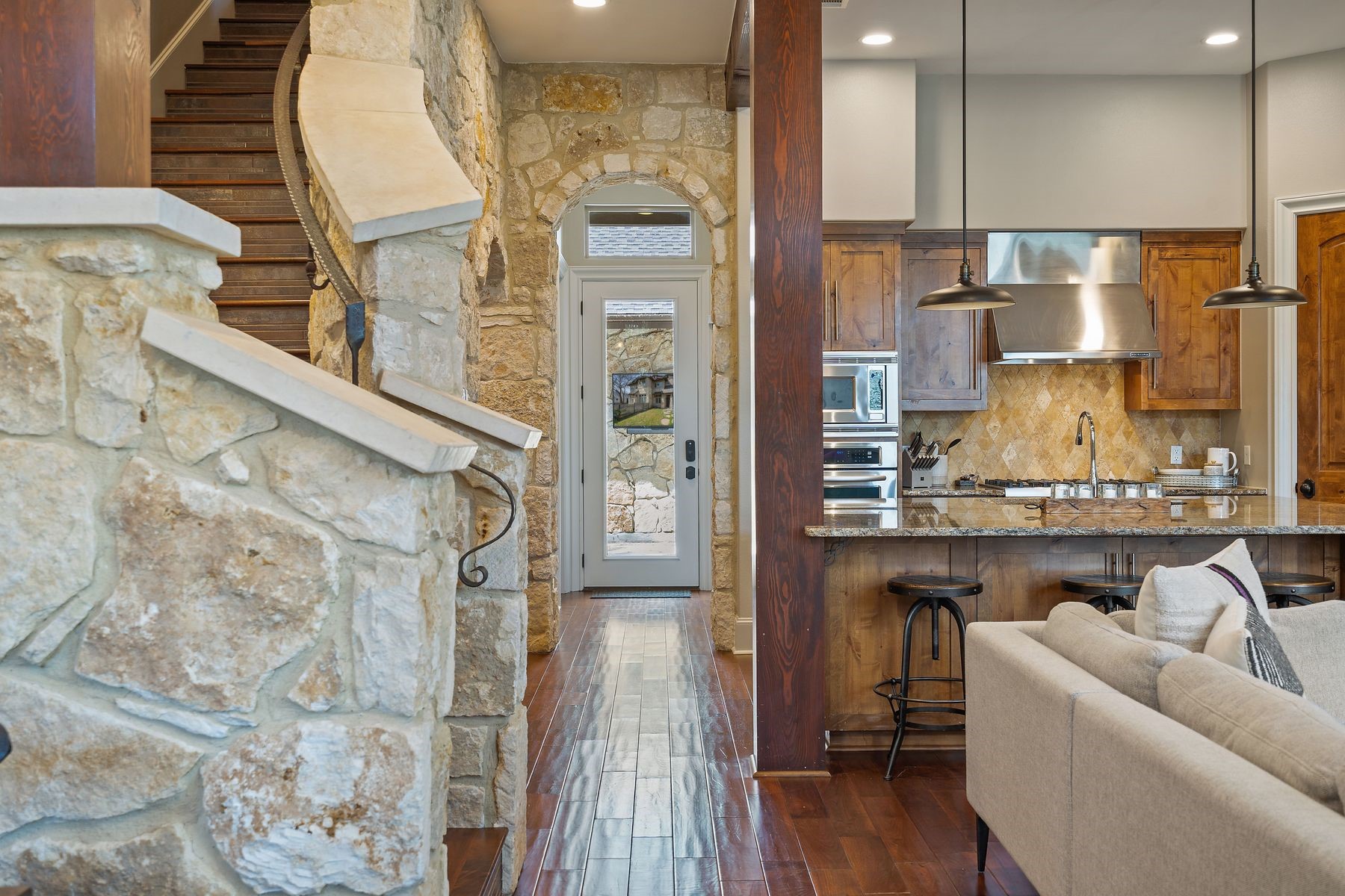 2002 Kinney Avenue, Unit B Austin, TX 78704 - Photo 13 of 34 Ascend the stunning wood and stone staircase, a captivating centerpiece that adds an element of natural beauty and architectural elegance to the home.