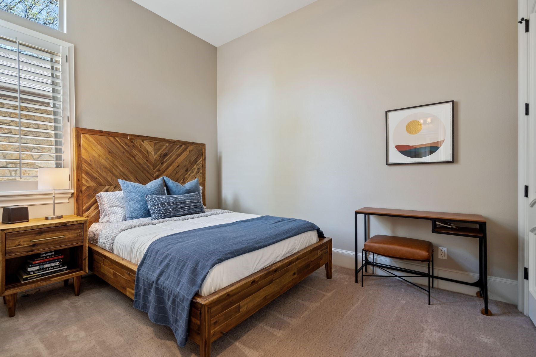 2002 Kinney Avenue, Unit B Austin, TX 78704 - Photo 21 of 34 Two guest rooms, each adorned with high ceilings and ceiling fans, offer comfort and privacy, with one boasting an en suite bathroom.