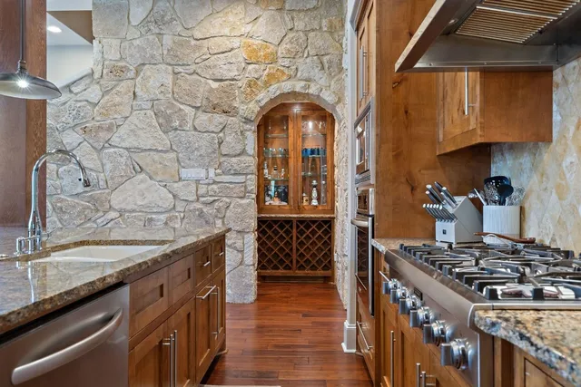a stove top oven sitting inside of a kitchen
