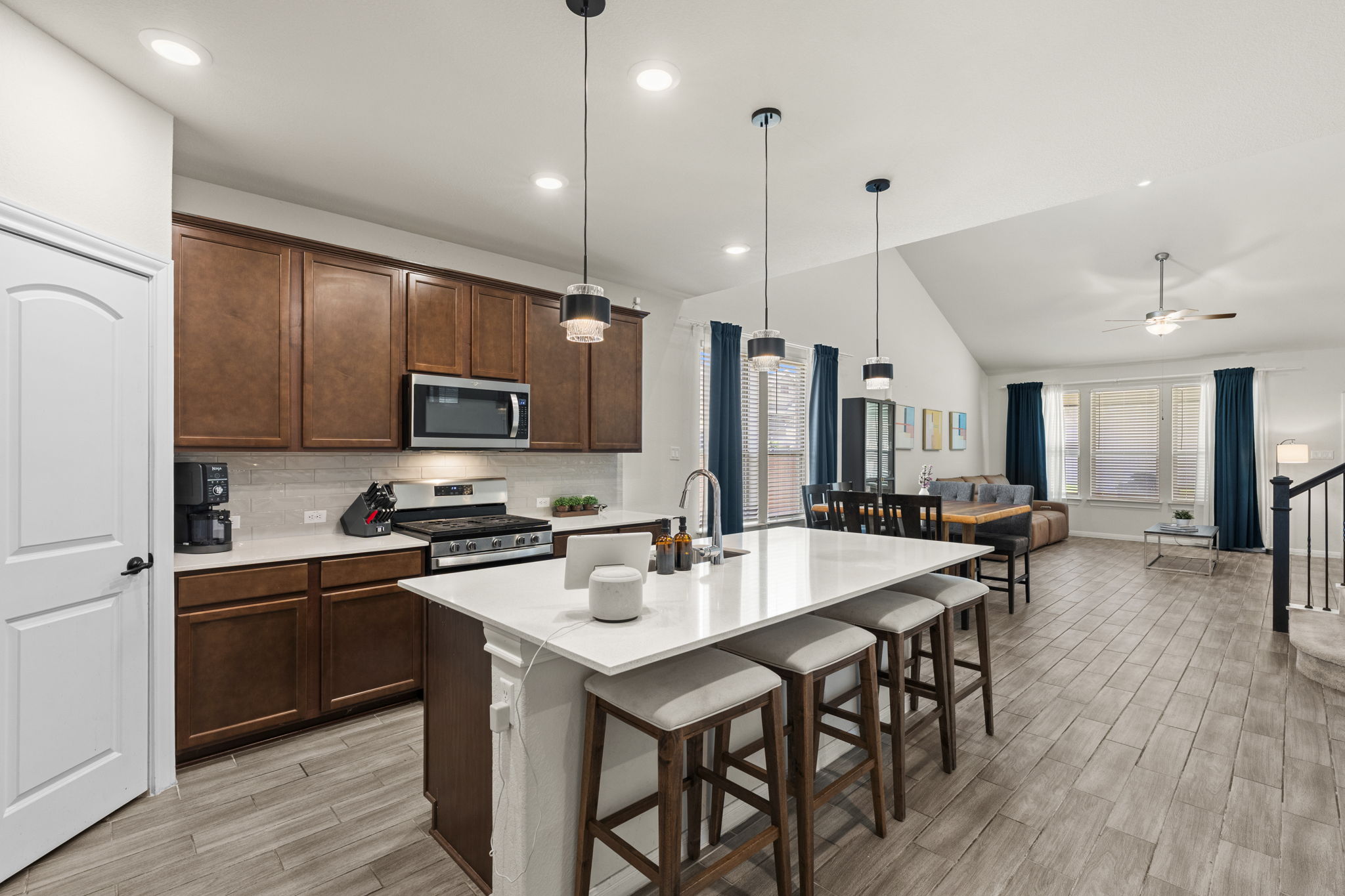548 Purple Heart Drive Buda, TX 78610 - Photo 2 of 35 An open concept design seamlessly connects the well-appointed kitchen to the adjacent living area.