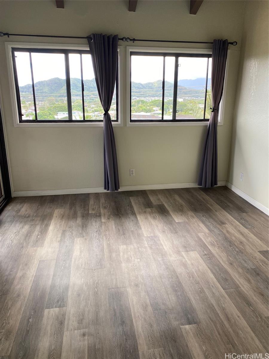 45-315 Lilipuna Road, Unit A306 Kaneohe, HI 96744 - Photo 15 of 19 an empty room with wooden floor and windows