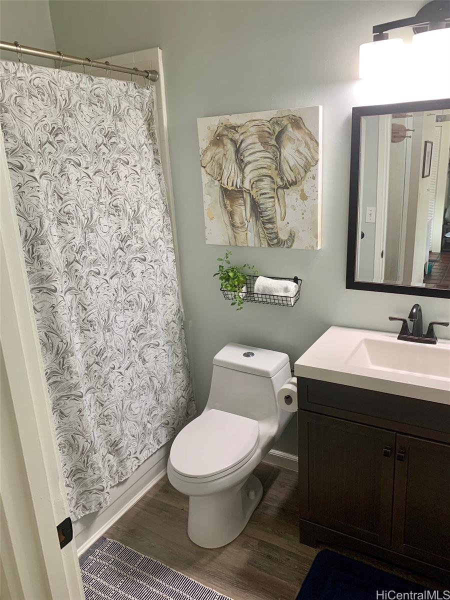 45-315 Lilipuna Road, Unit A306 Kaneohe, HI 96744 - Photo 16 of 19 a bathroom with a toilet and a shower curtain