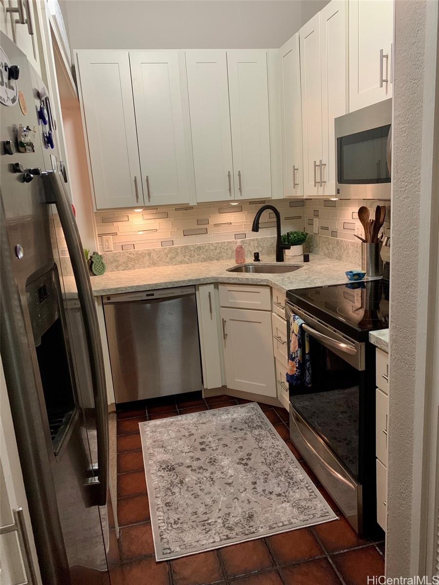 45-315 Lilipuna Road, Unit A306 Kaneohe, HI 96744 - Photo 5 of 19 a kitchen with granite countertop a sink stove and cabinets