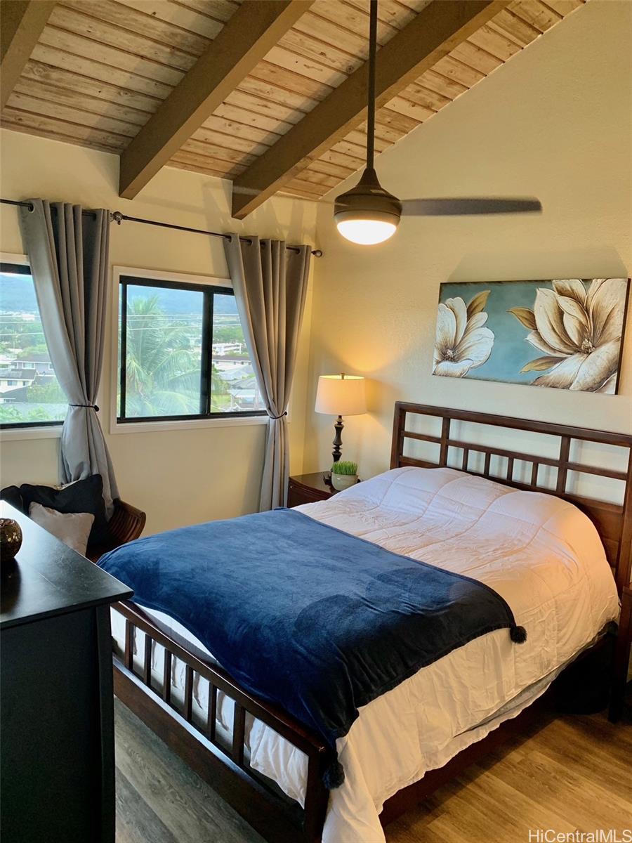 45-315 Lilipuna Road, Unit A306 Kaneohe, HI 96744 - Photo 8 of 19 a bed sitting in a bedroom next to a window