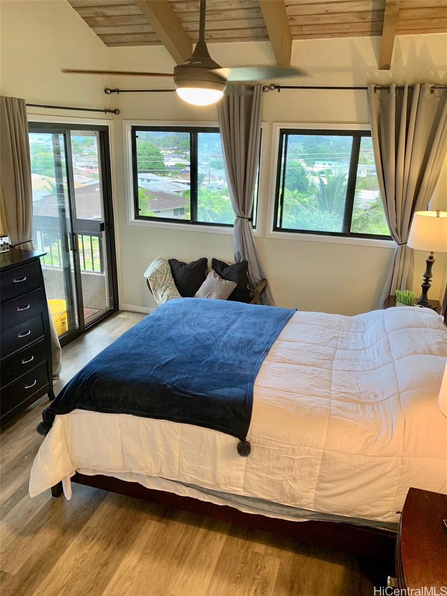 45-315 Lilipuna Road, Unit A306 Kaneohe, HI 96744 - Photo 9 of 19 a bedroom with a bed window and mirror