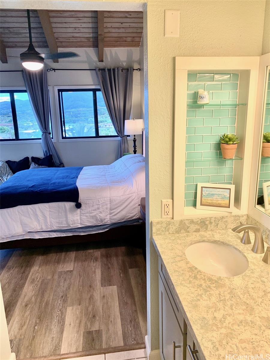 45-315 Lilipuna Road, Unit A306 Kaneohe, HI 96744 - Photo 10 of 19 a en suite bathroom with a granite countertop sink and a mirror