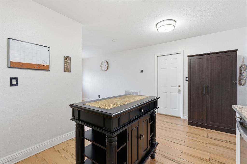 1130 8th Avenue Northeast Largo, FL 33770 - Photo 16 of 39 a room with a table and wooden floor