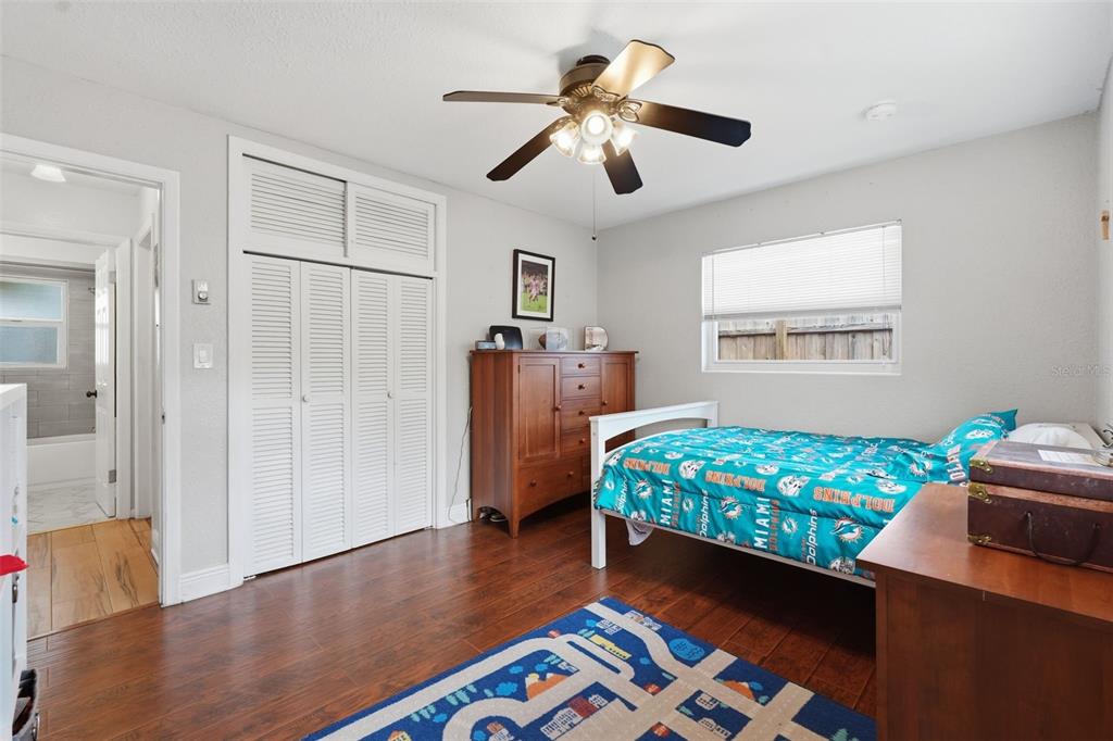 1130 8th Avenue Northeast Largo, FL 33770 - Photo 21 of 39 a bed room with a bed and a chandelier