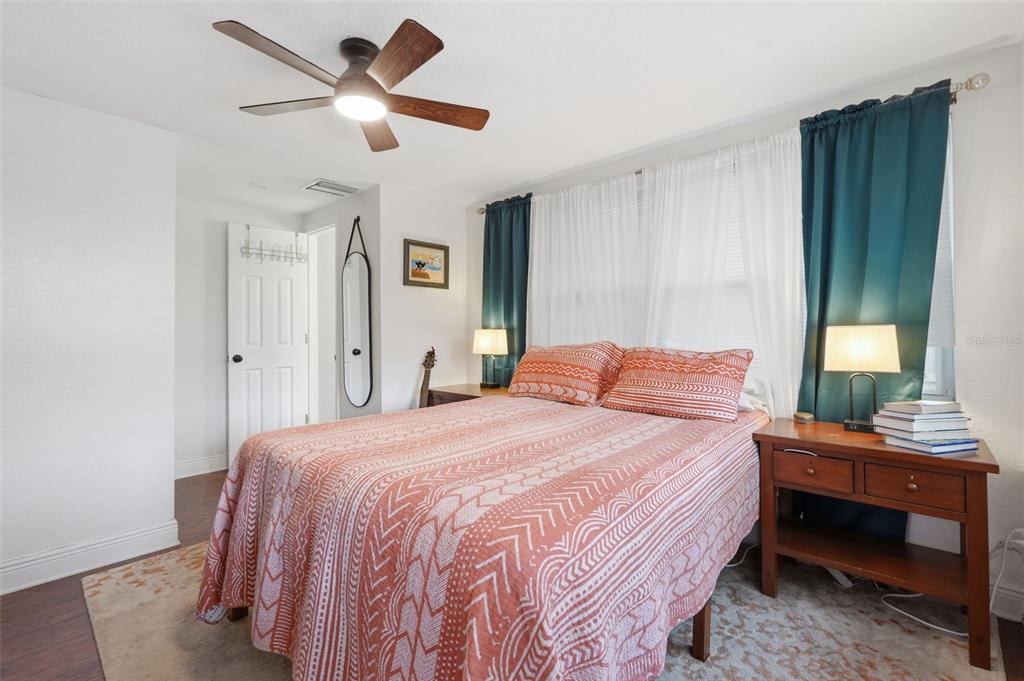 1130 8th Avenue Northeast Largo, FL 33770 - Photo 25 of 39 a bedroom with a bed and a chandelier
