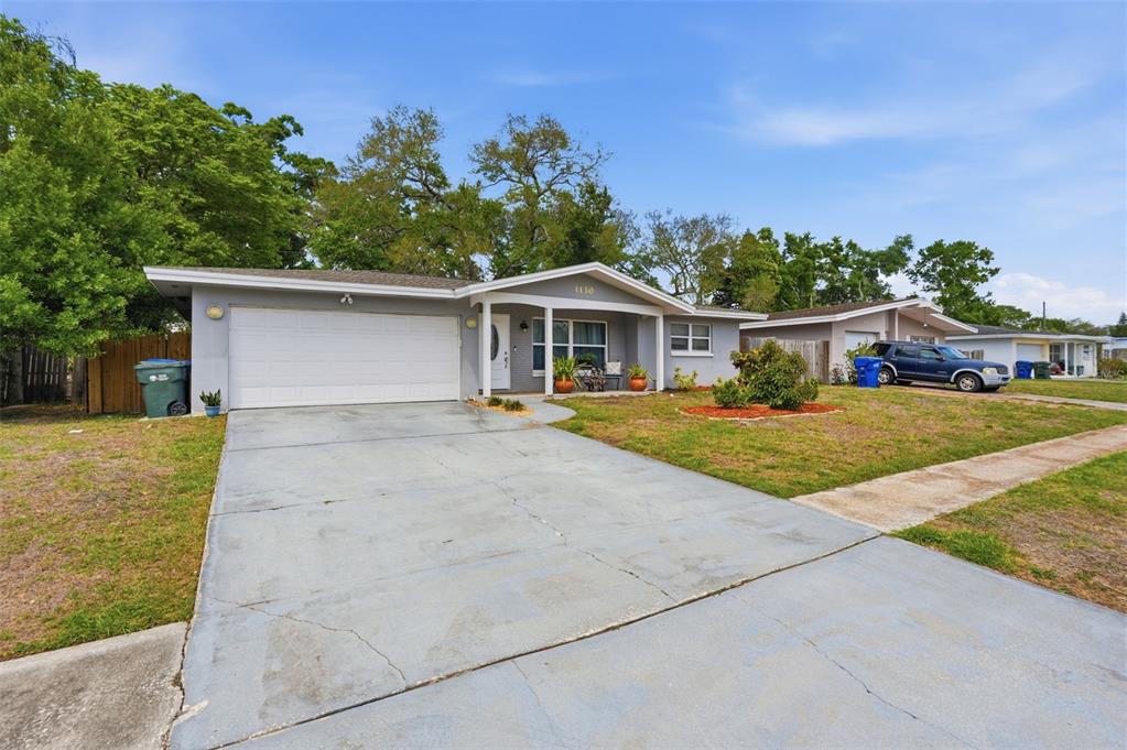 1130 8th Avenue Northeast Largo, FL 33770 - Photo 3 of 39 a front view of a house with a yard