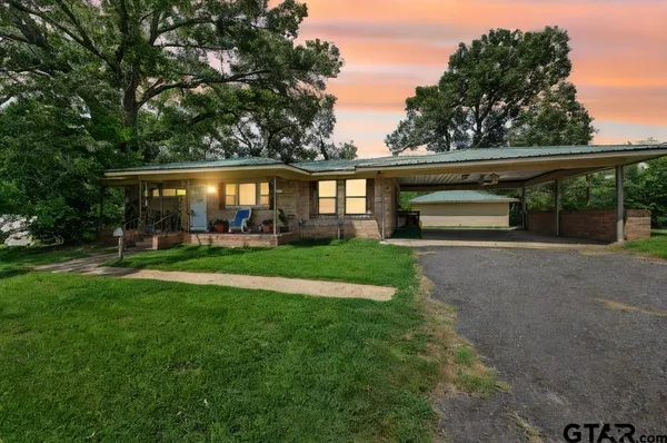 a view of house with yard and green space