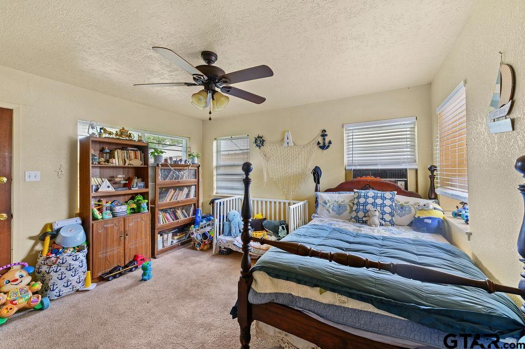 509 Tina Street Quitman, TX 75783 - Photo 12 of 17 a bedroom with furniture and a window