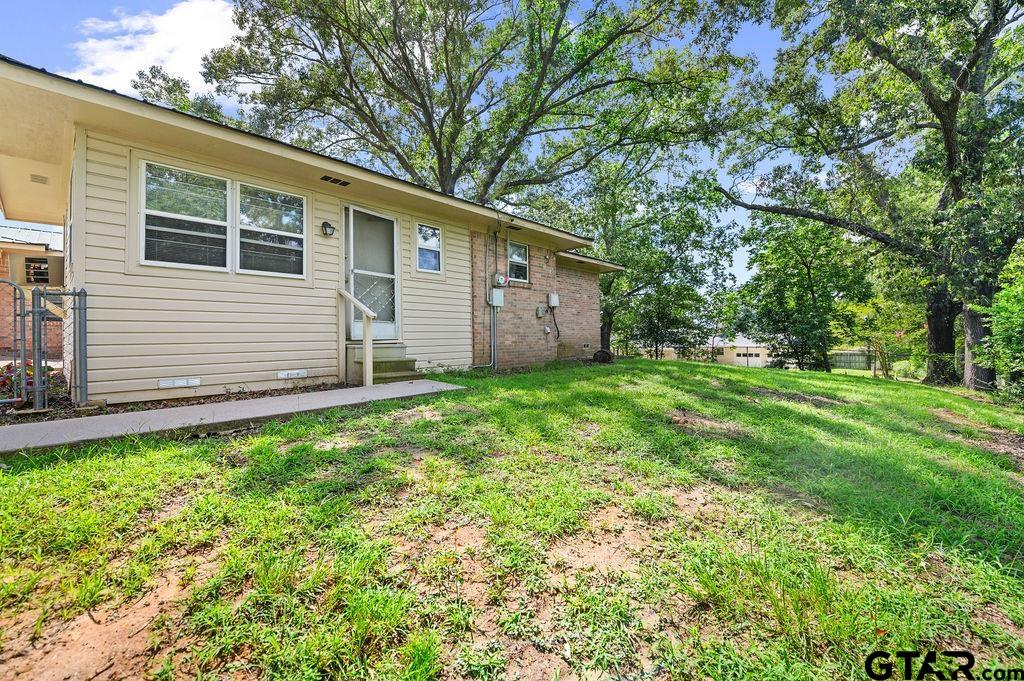 509 Tina Street Quitman, TX 75783 - Photo 14 of 17 a backyard of a house with lots of green space
