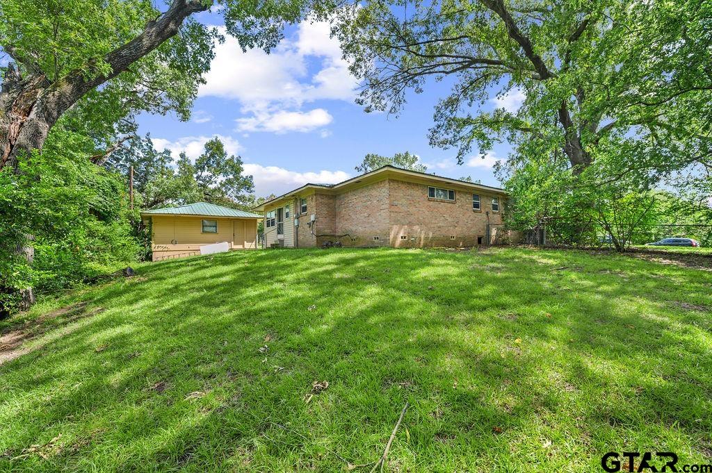 509 Tina Street Quitman, TX 75783 - Photo 15 of 17 a view of a house with a yard