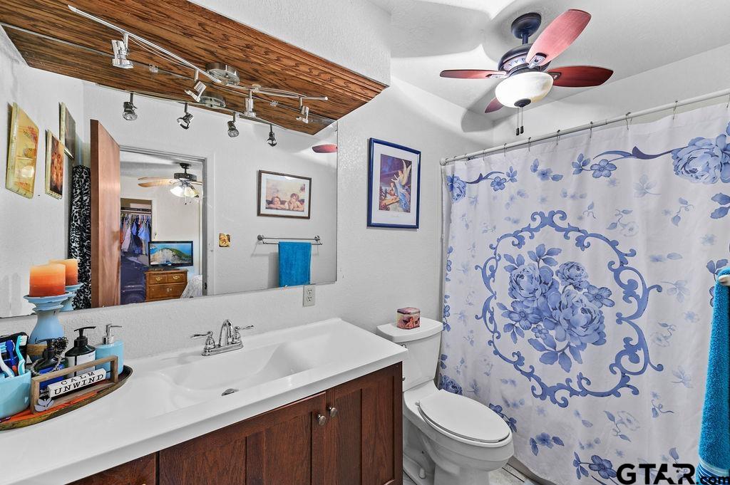 509 Tina Street Quitman, TX 75783 - Photo 17 of 17 a bathroom with a sink toilet vanity and shower