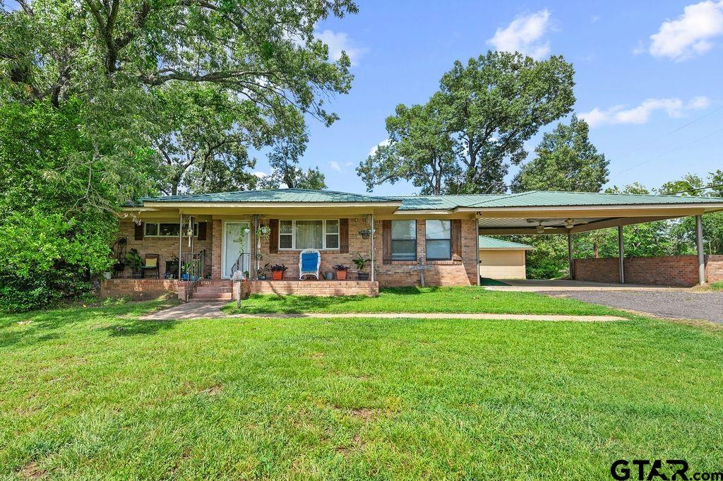 509 Tina Street Quitman, TX 75783 - Photo 2 of 17 a backyard of a house with table and chairs