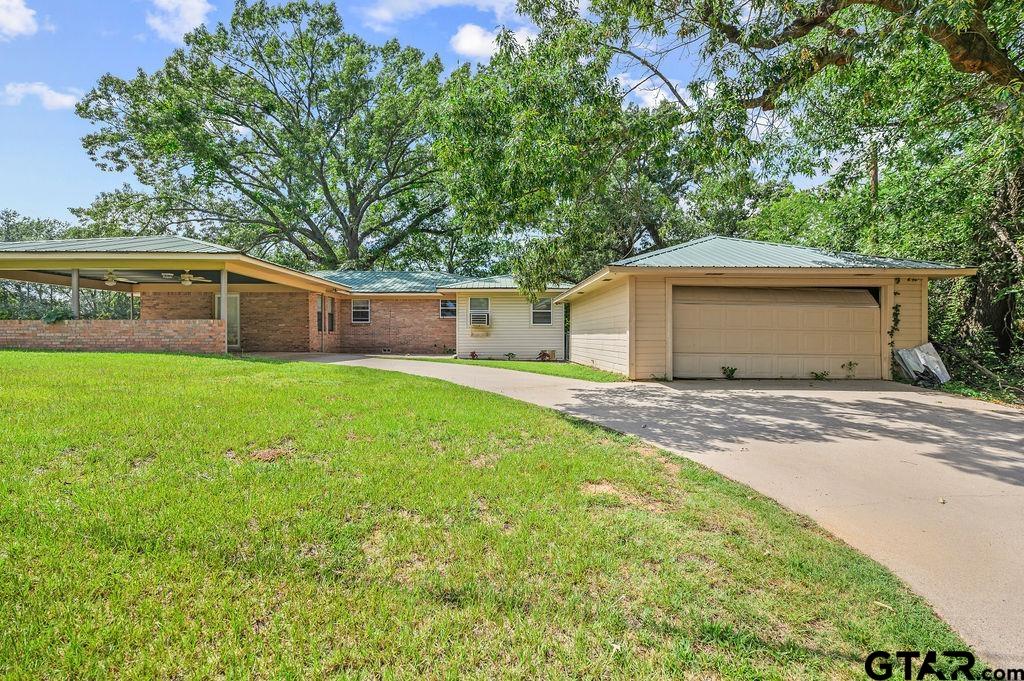 509 Tina Street Quitman, TX 75783 - Photo 3 of 17 a view of a house with a yard and a porch