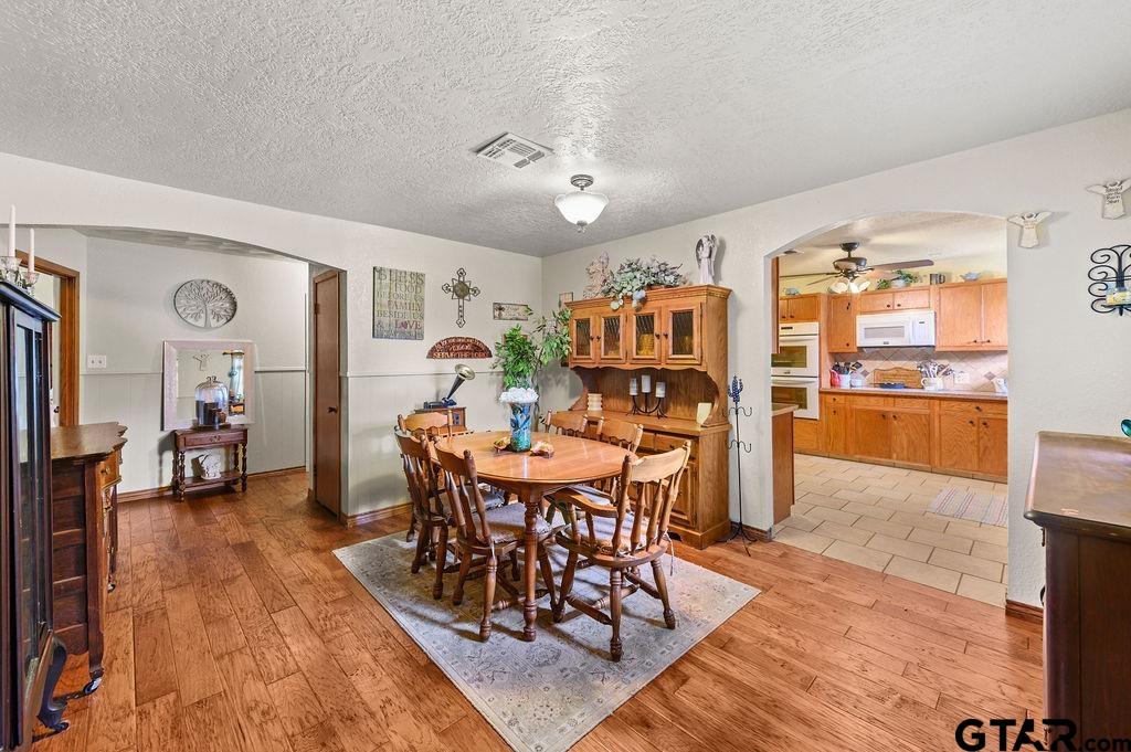 509 Tina Street Quitman, TX 75783 - Photo 6 of 17 a view of a dining room with furniture and wooden floor