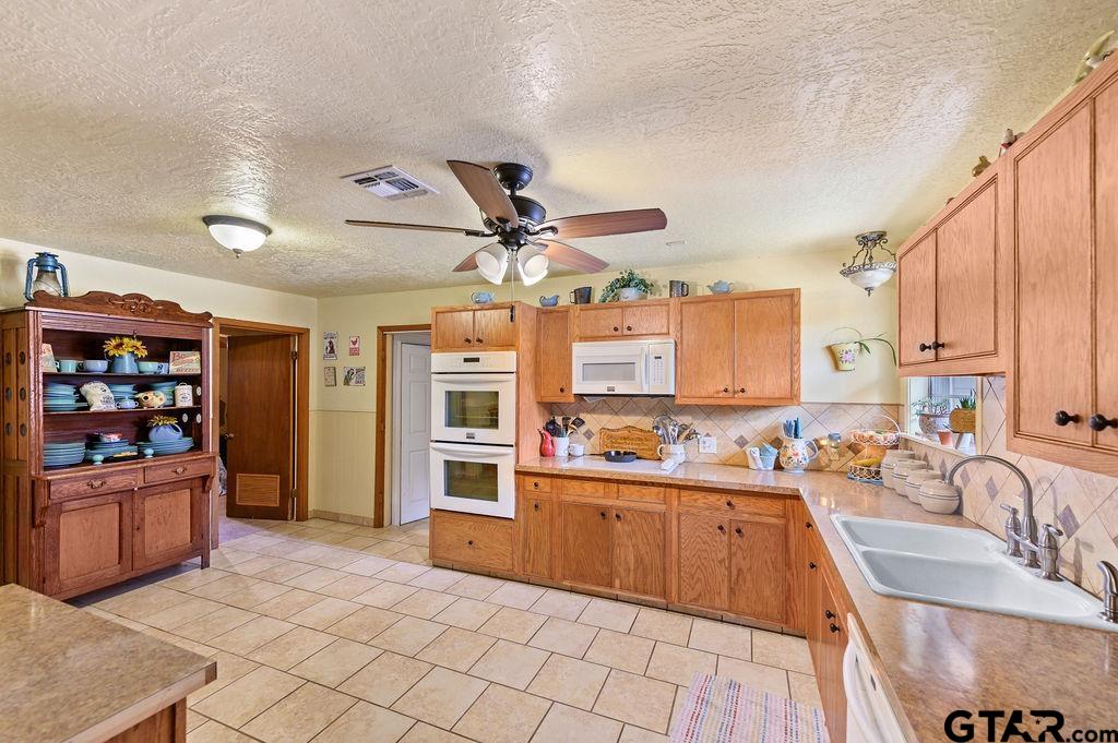 509 Tina Street Quitman, TX 75783 - Photo 7 of 17 a kitchen with stainless steel appliances granite countertop a sink and cabinets