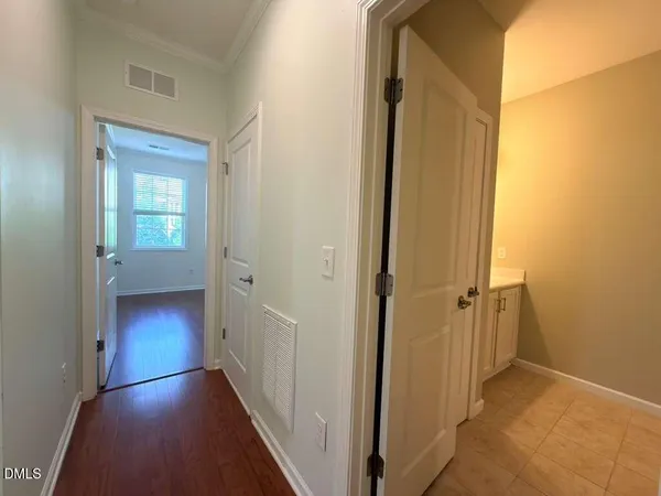 a view of a hallway with wooden floor