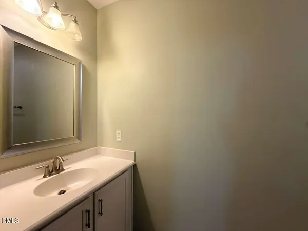 a bathroom with a sink and mirror