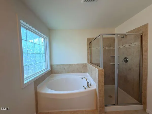 a bathroom with a bathtub and shower