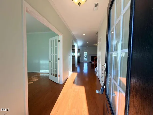 a view of a hallway with wooden floor
